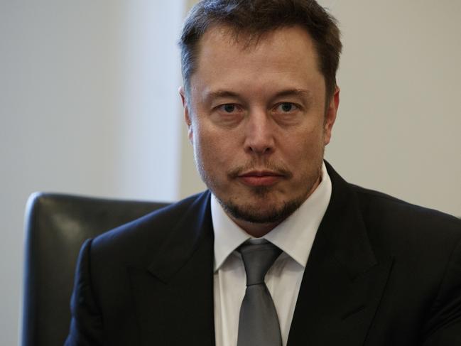 FILE - In this Dec. 14, 2016, file photo, Tesla CEO Elon Musk listens as President-elect Donald Trump speaks during a meeting with technology industry leaders at Trump Tower in New York., Musk promised on Twitter March 9, 2017, to solve an energy crisis in Australia or his companyâ€™s services are free. (AP Photo/Evan Vucci, File)