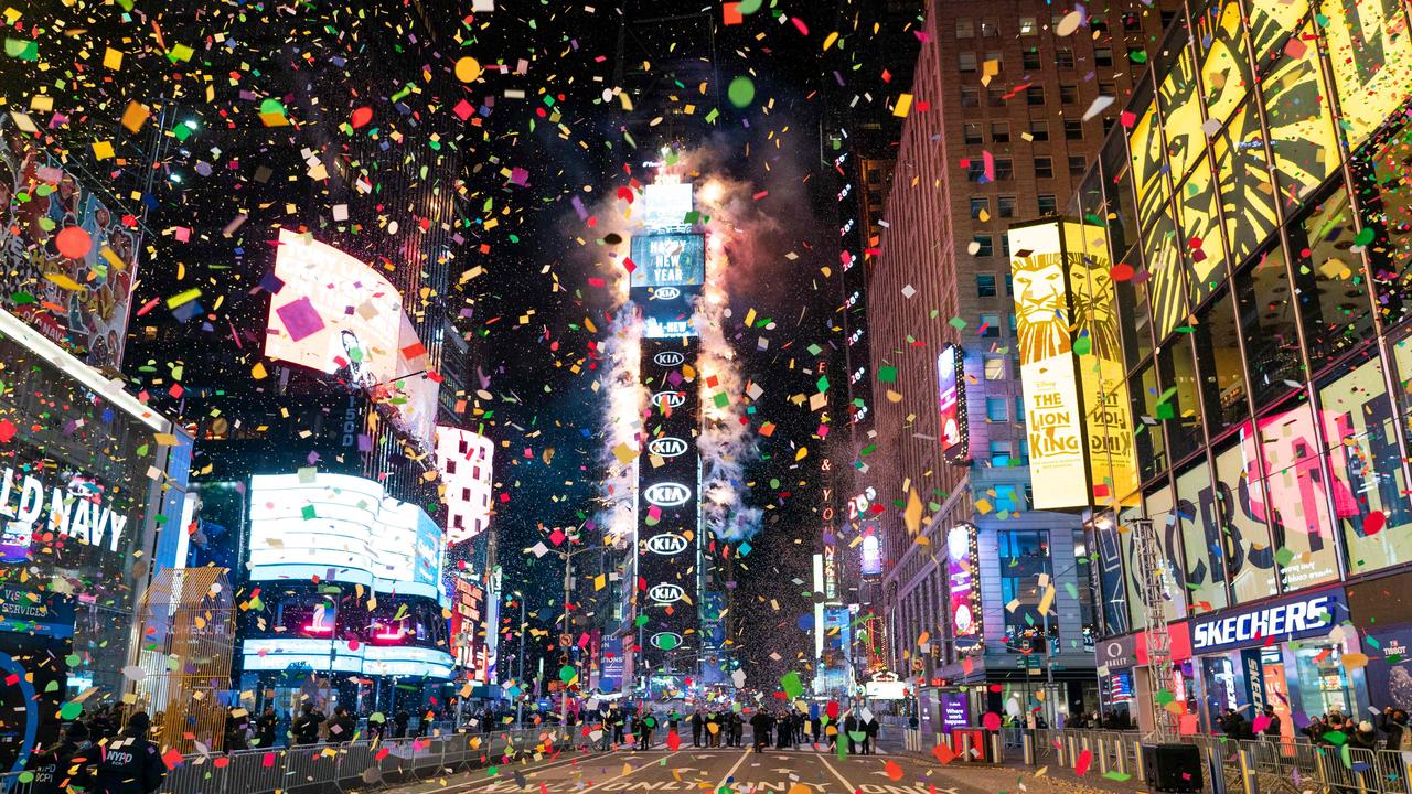 Confetti flies in the air on a mostly empty Times Square for New Year’s Eve. Due to the coronavirus outbreak Times Square was closed to all but a few revellers. Picture: Corey Sipkin / AFP