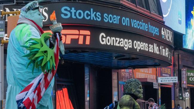 An electronic billboard in Times Square announces ‘stocks soar on vaccine hopes’ in New York. Picture: Getty Images/AFP