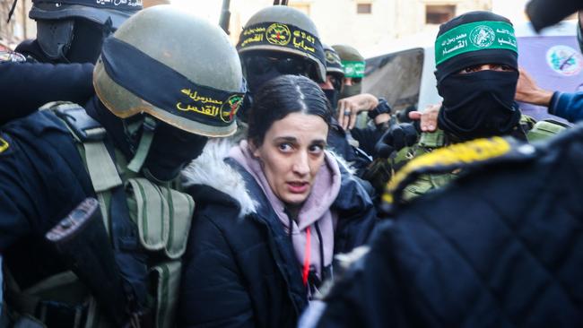 Palestinian militant group Islamic Jihad and Hamas fighters escort Israeli hostage Arbel Yehud (C) as she is mobbed by screaming crowds. Picture: AFP.