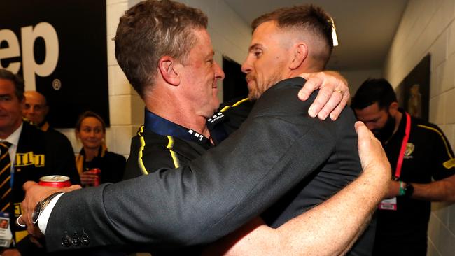 Damien Hardwick hugs Brett Deledio in the Richmond rooms after the Grand Final.