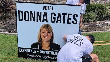 Volunteers quick to put up Donna Gates’ corflutes.