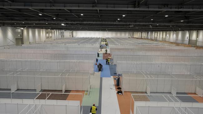 Work in progress to turn the ExCel centre into a temporary hospital — the NHS Nightingale hospital, in London. The makeshift hospital will comprise of two wards with the capacity to hold 2000 people in each. Picture: Andrew Parsons/10 Downing Street/via AP