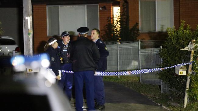 Police officers at the crime scene early on Sunday. Picture: Steve Tyson