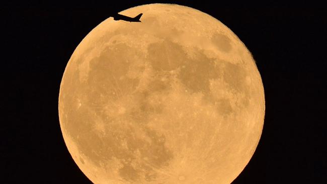 An aeroplane flies in front of the supermoon in September 2015 in Tokyo, Japan. Picture: The Asahi Shimbun- Getty Images.