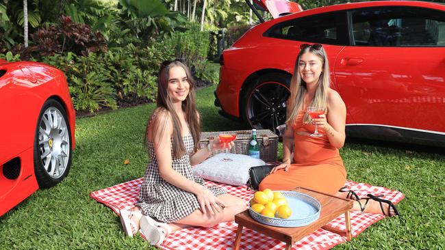 The Cairns Italian Festival begins from July 28. Chelsea Williamson and Lily Hayes enjoy a cocktail each beside some Ferraris. Picture: Brendan Radke