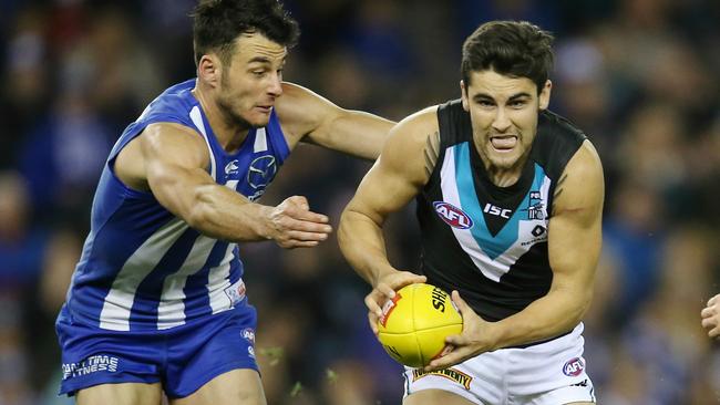 Robbie Tarrant tries to stop Chad Wingard. Picture: Michael Klein