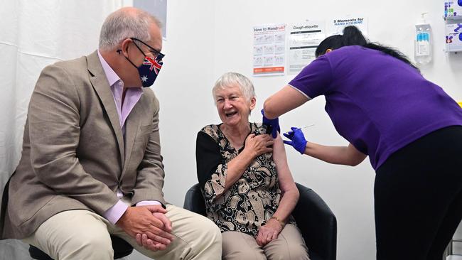 Scott Morrison looks on as Jane Malysiak, 84, receives the first COVID vaccination in Sydney on Sunday. Picture: AFP