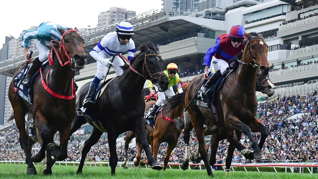 James McDonald lifts Romantic Warrior (left) to victory in the Hong Kong Cup. Picture: Grant Peters - Trackside Photography