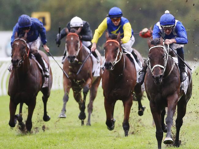 Winx ridden by Hugh Bowman (right) takes the lead to win the China Horse Club George Ryder race during Golden Slipper Day at Rosehill Racecourse in Sydney, Saturday, March 18, 2017. (AAP Image/David Moir) NO ARCHIVING, EDITORIAL USE ONLY