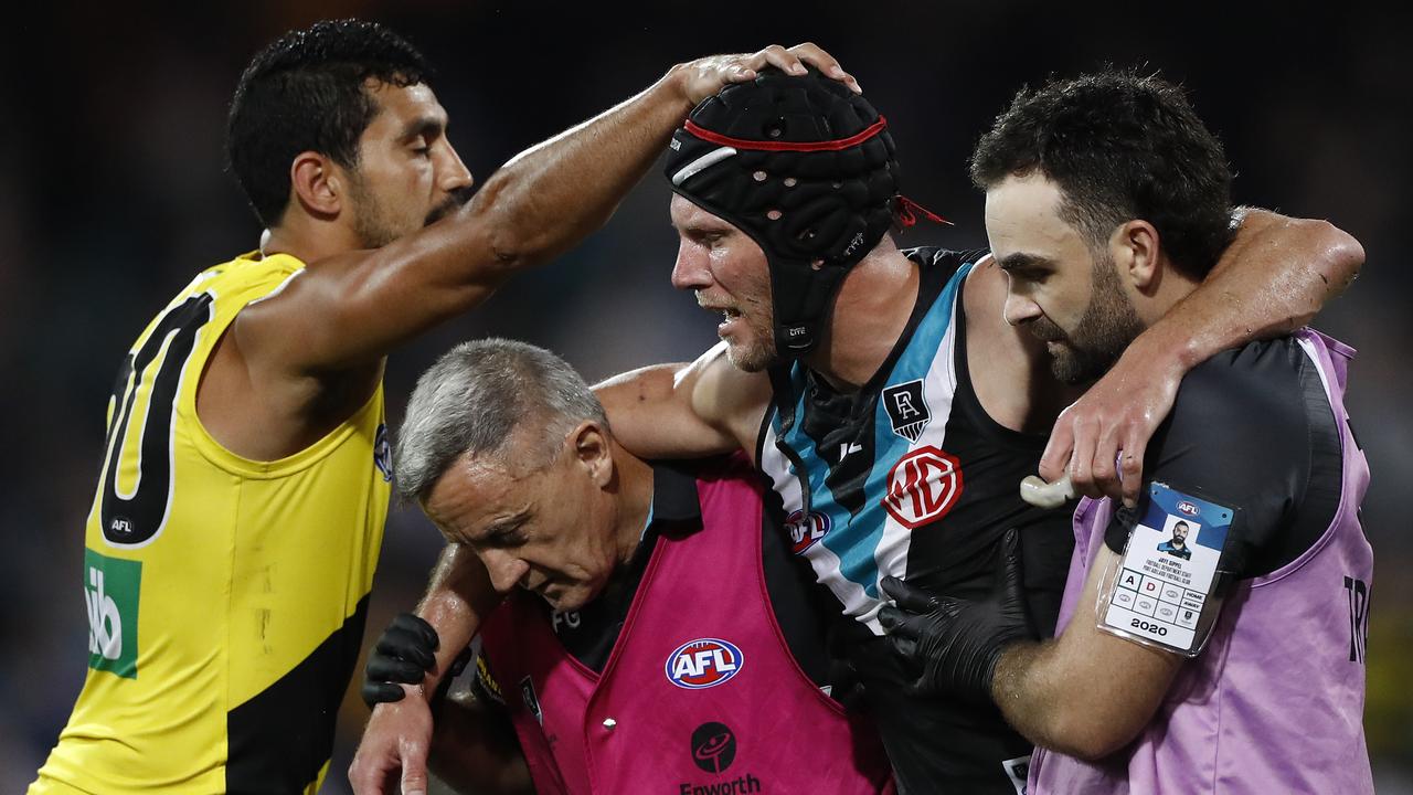 Marlion Pickett acknowledges Brad Ebert as he is taken from the ground in the preliminary final.