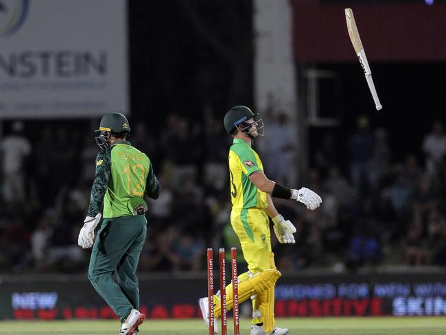 D'Arcy Short, right, tosses his bat in the air after he was run out by South African wicketkeeper Quinton De Kock. Picture: APPhoto/Halden Krog