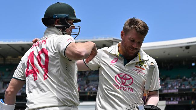 Australiaâs Steve Smith (L) hugs teammate David Warner who walks out after dismissal for the last time in his 112th and farewell Test on day four of the third cricket Test match between Australia and Pakistan at the Sydney Cricket Ground in Sydney on January 6, 2024. (Photo by Saeed KHAN / AFP) / -- IMAGE RESTRICTED TO EDITORIAL USE - STRICTLY NO COMMERCIAL USE --