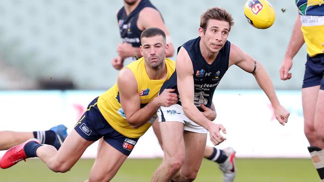 Eagles’ Jimmy Toumpas tries to contain South’s Joel Cross Picture: Sarah Reed