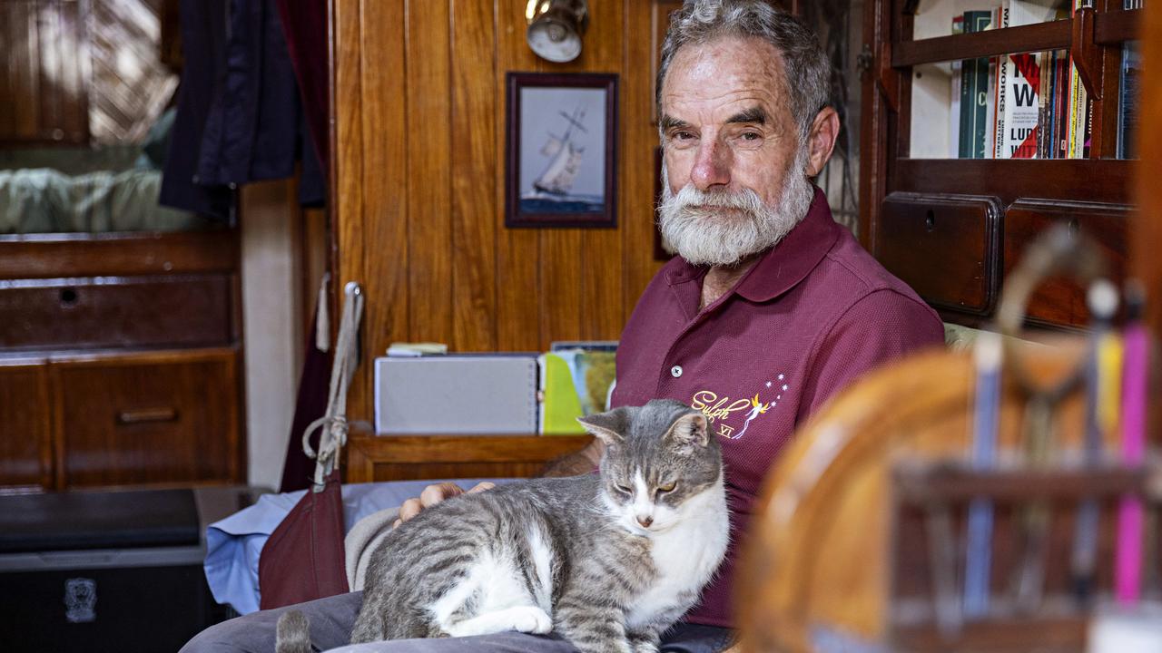 Bob Williams with his cat Oli who will sail in the Sydney to Hobart yacht race on board Sylph VI. Picture: Adam Yip