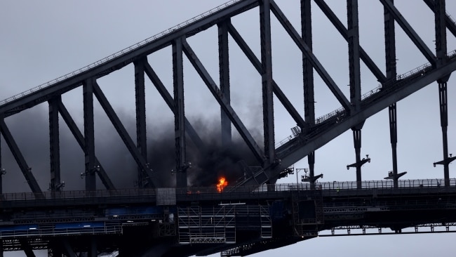 Flames are seen on the Sydney Harbour Bridge after the collision. Picture: Brendon Thorne/Getty Images