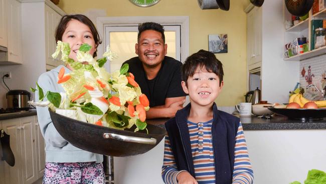 Soi 38 chef Terry Intarakhamhaeng cooking Wombok with his children Adelaide, 10 and Bertie, 7. Photo: Brenton Edwards.