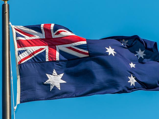 The Australian flag against clear blue sky