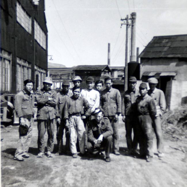 Allan Chick in 1948 with his workmates at the factory where he used to work as a POW in Nagasaki.