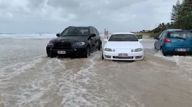 Large waves caused by Tropical Cyclone Oma have combined with king tides to create havoc on beachside suburbs on the Gold Coast. Water can be seen rushing over a carpark outside Currumbin Vikings Surf Life Saving Club in Currumbin. Footage: Adam Head.