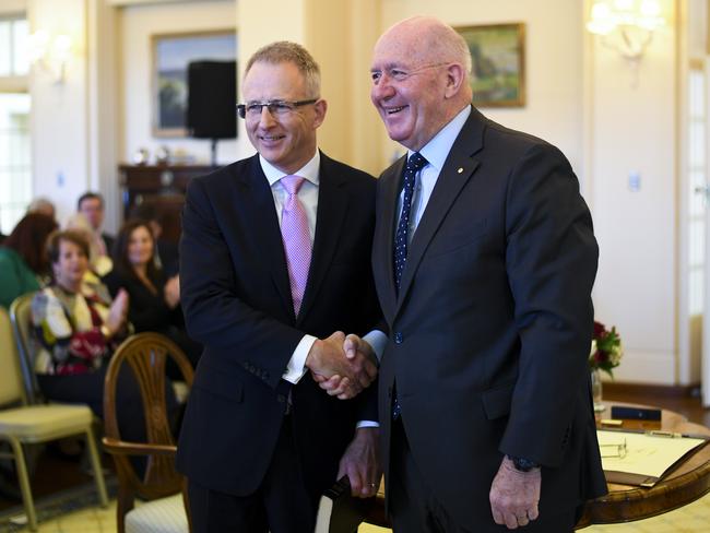 Paul Fletcher MP (left) shakes hands with Australian Governor-General Sir Peter Cosgrove after being sworn-in as Australian Families Minister during a ceremony at Government House in Canberra. Picture: Lukas Coch