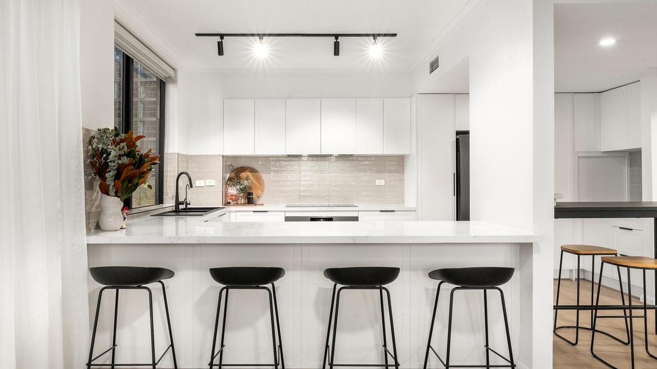 A 90cm induction cooktop and oven, dishwasher, large engineered stone benchtops and filtered water tap feature in he kitchen.