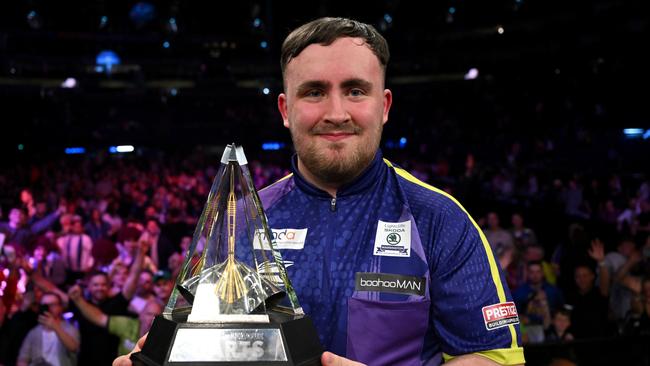 Luke Littler celebrates with the trophy after winning the Final match of the Premier League Darts Play-Offs in London. (Photo by Justin Setterfield/Getty Images)