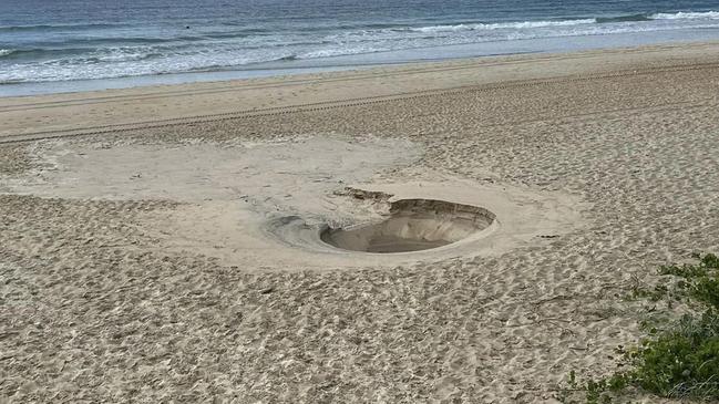 A two metre hole erupted in the middle of Main Beach. Picture: Supplied