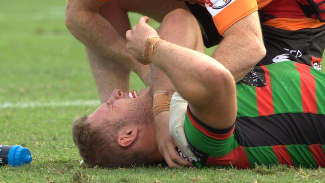 Tom Burgess winces in pain after a cheap shot.