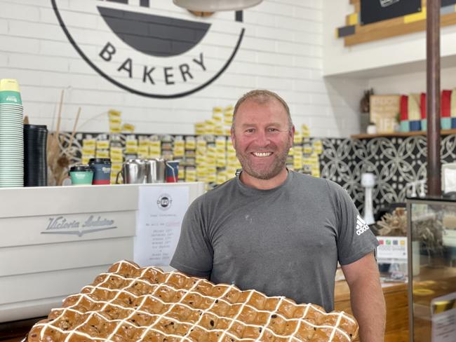 Owner of Warrnambool’s Browns Depot Bakery Nick Brown holding a fresh batch of traditional hot cross buns.