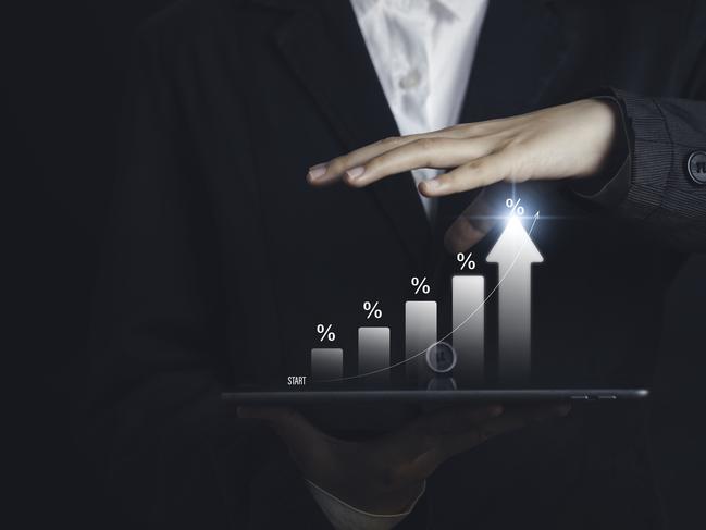 l businessman calculating investment income on a tablet with percentage symbol and up arrow, Interest rates continue to increase, return on stocks compound interest generic