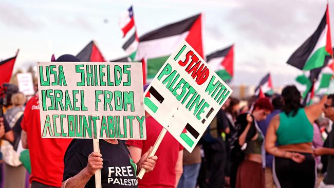 Members of the Australian Palestinian community holding flags and placards during a protest at the Port Botany terminal in Sydney on November 21. Picture: David Gray/AFP