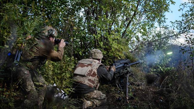 Ukraine infantry fire a US-made MK-19 grenade launcher towards Russian positions less than 800m away in the Donetsk region on Wednesday. Picture: AFP