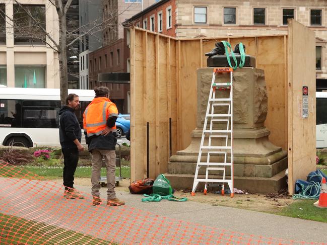 Workers from International Conservation Services begin final work of removing Crowther statue. Picture: Craig Herbert