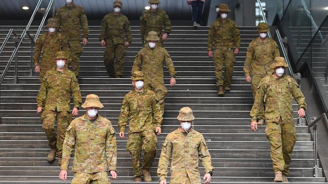 Members of the Australian Defence Force walk through the city on Monday. Picture: Getty