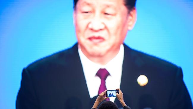 China's President Xi Jinping is seen on a big screen in the media centre at the opening of  the China International Import Expo in Shanghai yesterday. Picture: AFP