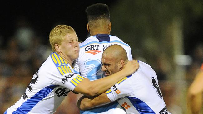 Parramatta Eels prop Daniel Alvaro and teammate Tim Mannah put the press on Gold Coast Titans Leva Li during Saturday nights pre-season match at Anzac Oval in Alice Springs.