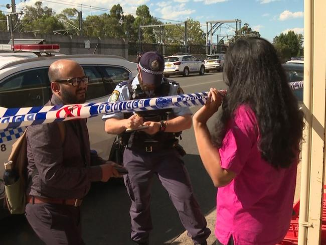 A woman talks to police at the crime scene. Picture: TNV