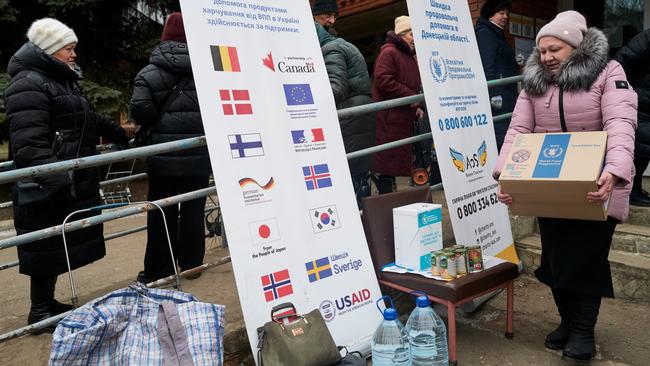 Ukrainians receive food rations from the World Food Program, to which USAID contributes. Pictures: Getty Images