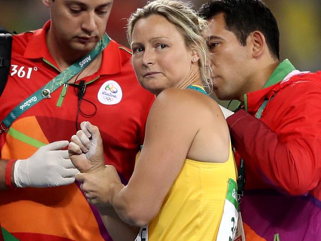 RIO DE JANEIRO, BRAZIL - AUGUST 16: Kim Mickle of Australia is assisted by medical staff after being injured during the Women's Javelin Throw Qualifying Round on Day 11 of the Rio 2016 Olympic Games at the Olympic Stadium on August 16, 2016 in Rio de Janeiro, Brazil. (Photo by Cameron Spencer/Getty Images)