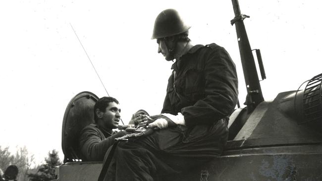 Two soldiers speak together in an armored personnel carrier in Bucharest. Picture: Hedley Thomas