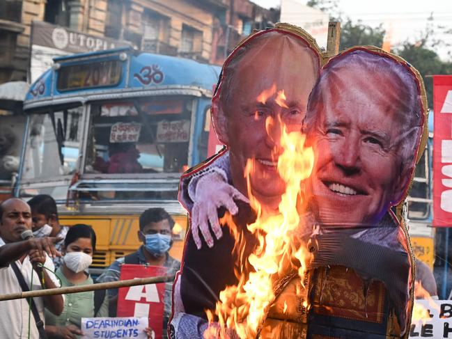 Protesters burn a cut-out Vladimir Putin and Joe Biden in Kolkata. Picture: Dibyangshu Sarkar/AFP