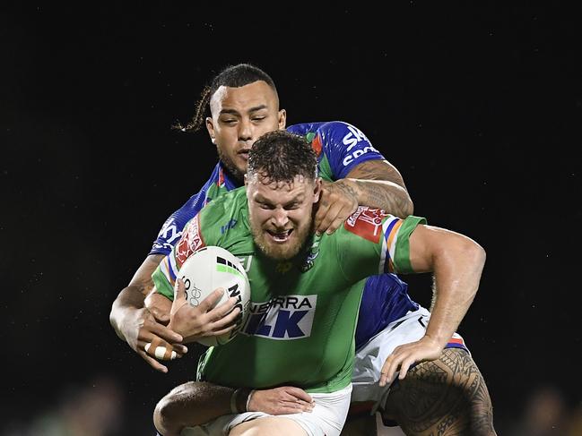 Elliott Whitehead of the Raiders is tackled by Sean O'Sullivan and Addin Fonua-Blake of the Warriors during the round 24 NRL match between the New Zealand Warriors and the Canberra Raiders at BB Print Stadium, on August 27, 2021, in Mackay, Australia. Picture: Ian Hitchcock