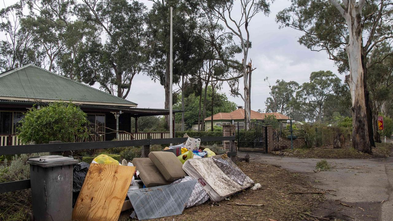 Sodden furniture was seen placed out the front of homes. Picture: NewsWire / Simon Bullard.