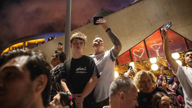 People film the midnight fireworks. Picture: Mark Stewart