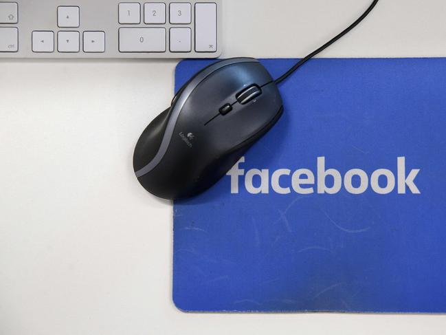 (FILES) This file photo illustration taken on December 4, 2017 shows mousepad with the Facebook logo at Facebook's new headquarters at Rathbone Place in central London. - Facebook was branded "arrogant" and "unconscionable" for banning Australian users from sharing news on February 18, 2021, as its defiant response to government regulation inadvertently crippled the pages of several emergency services. (Photo by Daniel LEAL-OLIVAS / AFP)