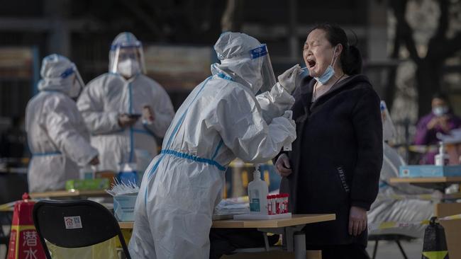 A health worker swabs a local resident at a mass Covid testing site in Beijing, China. Picture: Getty