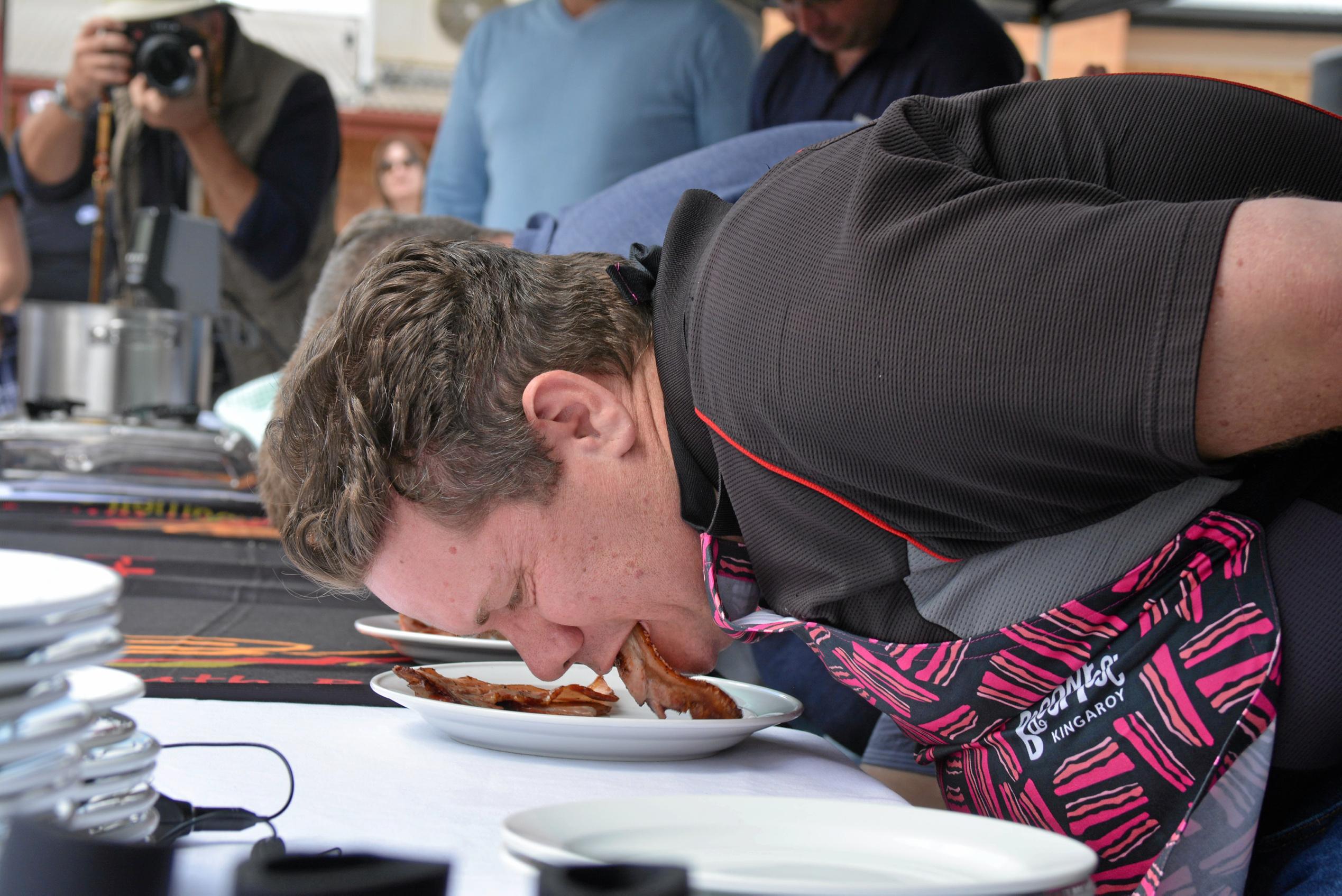 Competitors fight for the top spot at the bacon eating competition during Kingaroy's BaconFest on Saturday August 25. Picture: Jessica McGrath