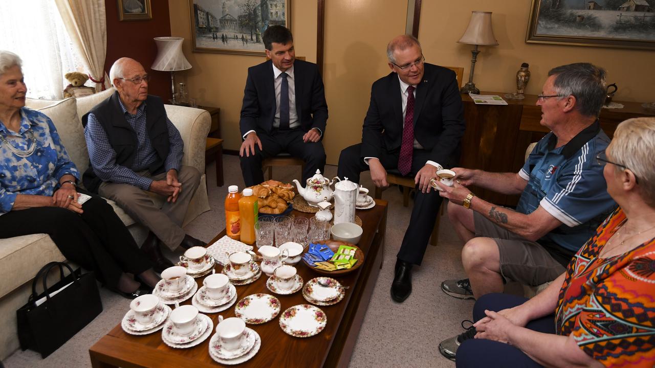 PM Scott Morrison (centre, right) and Australian Energy Minister Angus Taylor (centre, left) speak to homeowners Avril and Colin Greef (right) and seniors Arthur and Edith Parnwell about cost of energy. Picture: Lukas Coch/AAP