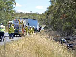 Emergency services on the scene of a fatal collision between a semi trailer and bike on the New England Highway. Picture: Gerard Walsh